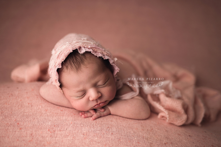 newborn baby wearing filly bonnet