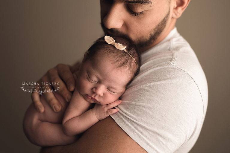 sleeping newborn with dad