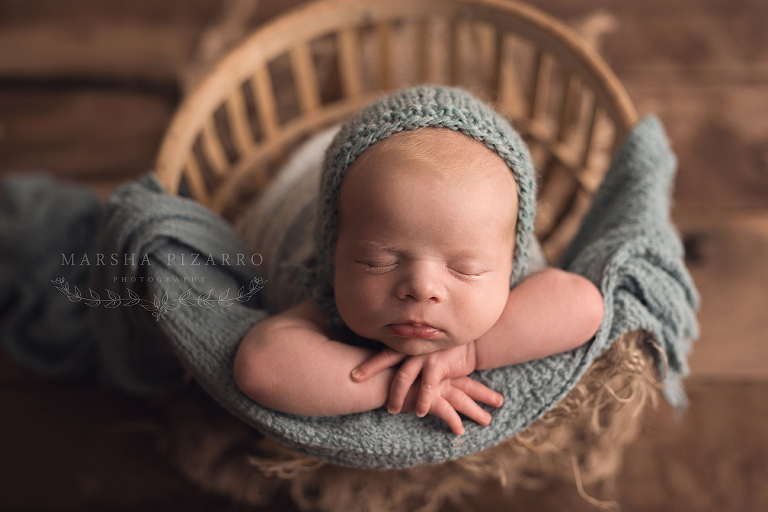 newborn baby boy wrapped in blue 