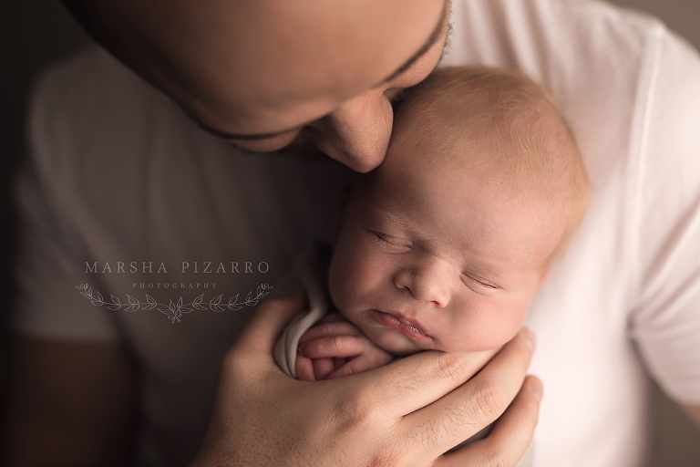 newborn baby gets a kiss