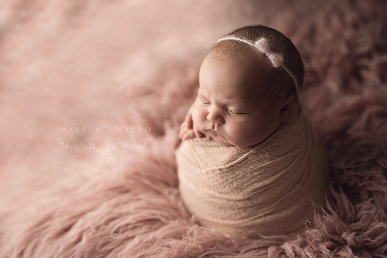 newborn session with pink wrap