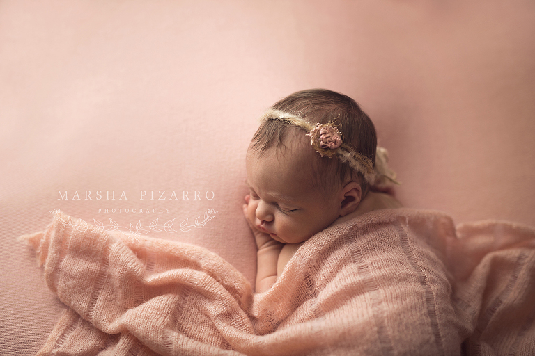baby girl wrapped in pink blanket