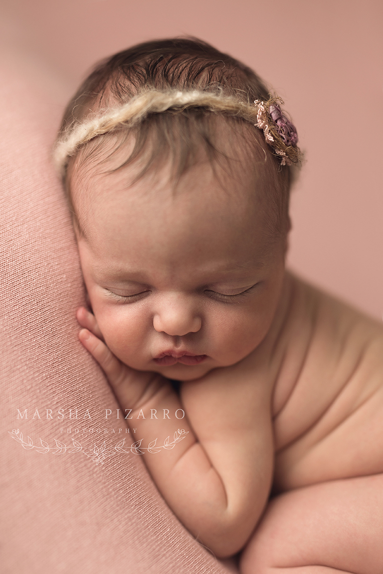 newborn girl wearing pink headband