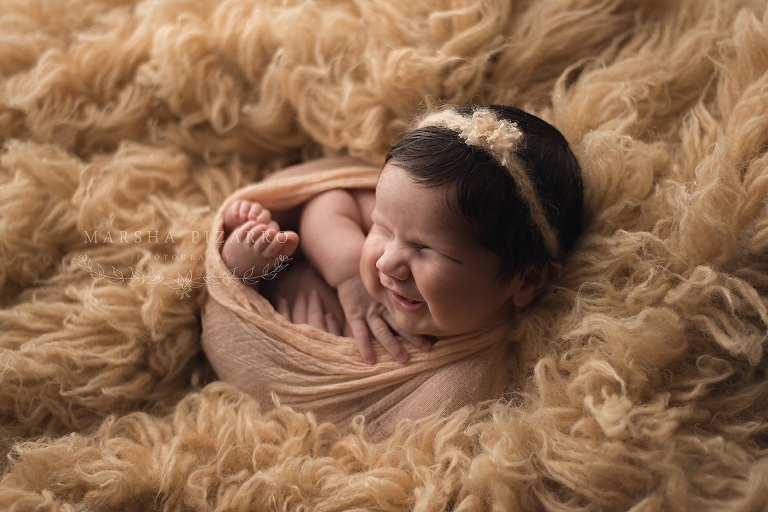 newborn wearing headband in newborn photography workshop